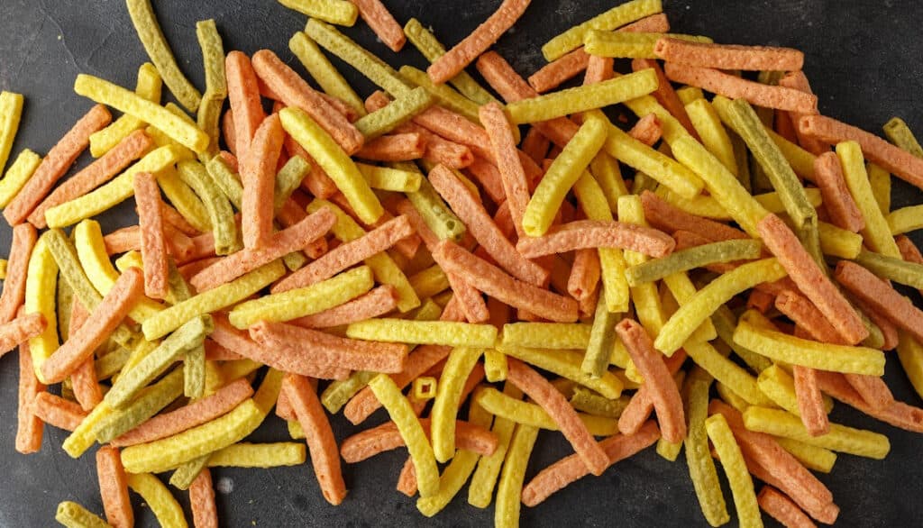 picture of a pile of veggie straws on a black background