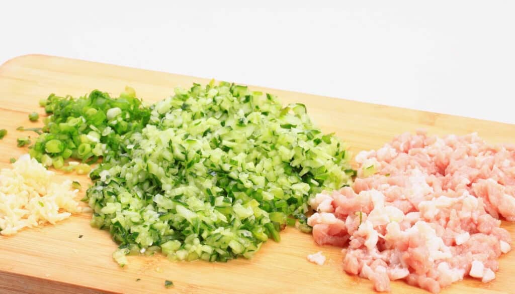 chopped vegetables and chicken on a cutting board