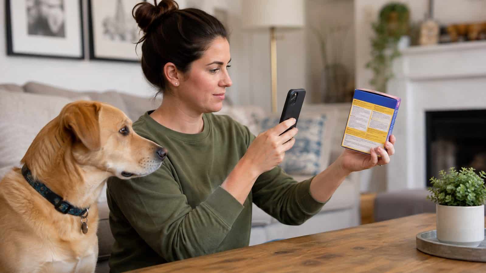 Dog owner photographing a cat dewormer package after an accidental dose